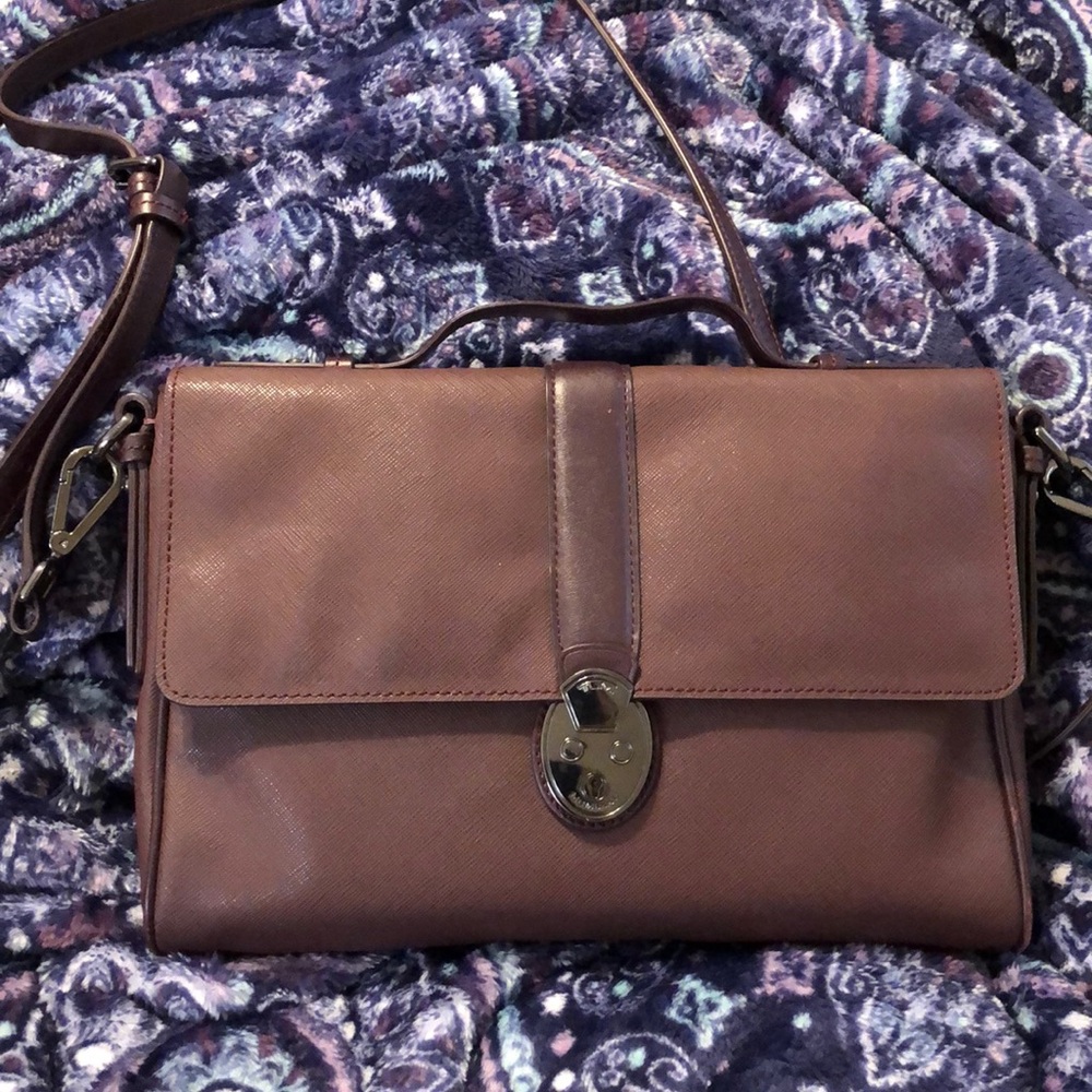 Tumi crossbody bag with small handle on top.